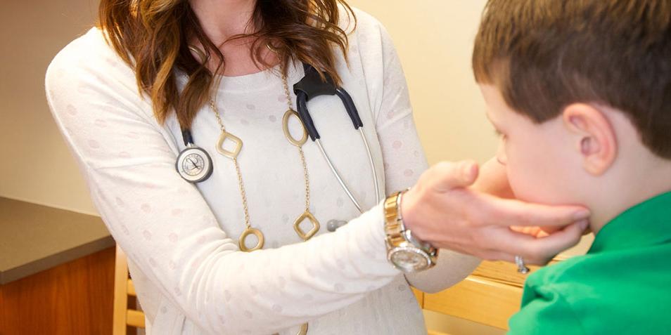 Student nurse working with child patient