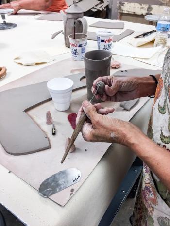 Student working with clay in class