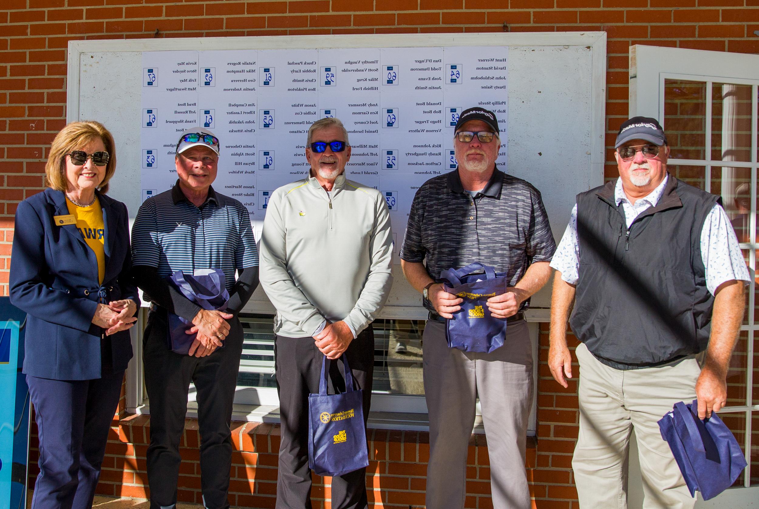 One of the winning teams standing with Dr. Spalding receiving their prizes