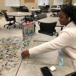 Student putting together puzzle